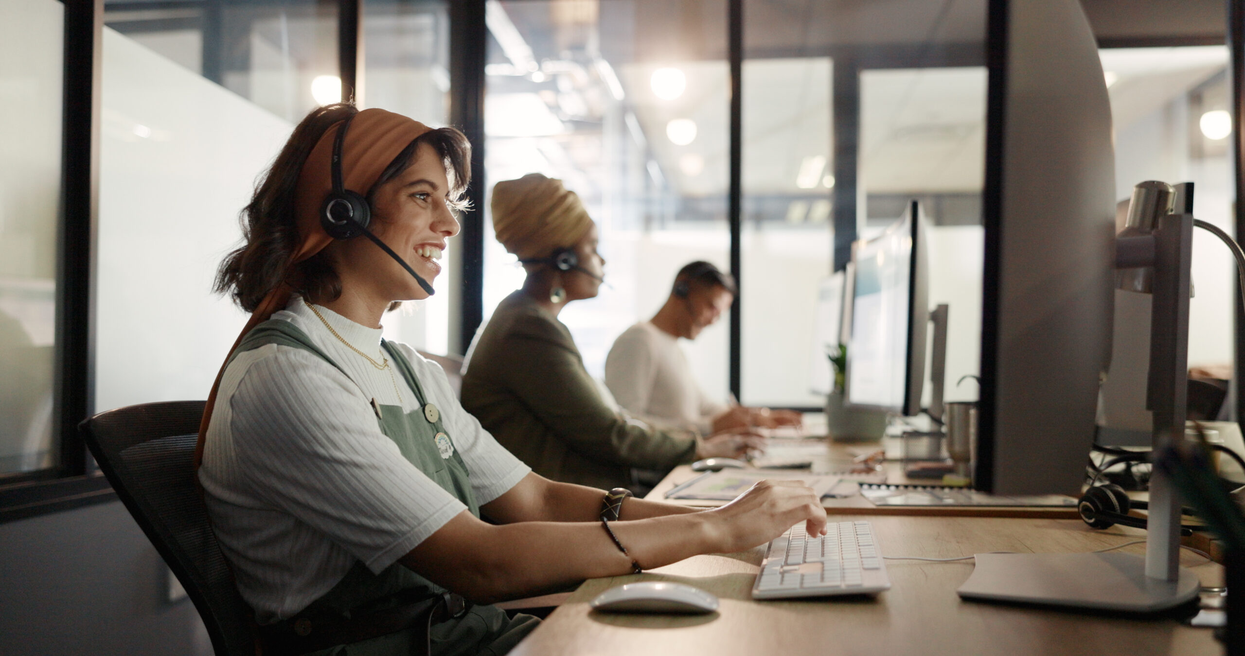 Three employees working at their computers.